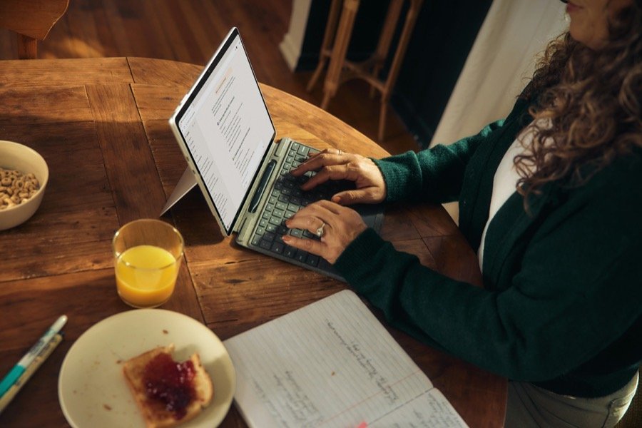 Jeune indépendante préparant sa facture sur un ordinateur portable
